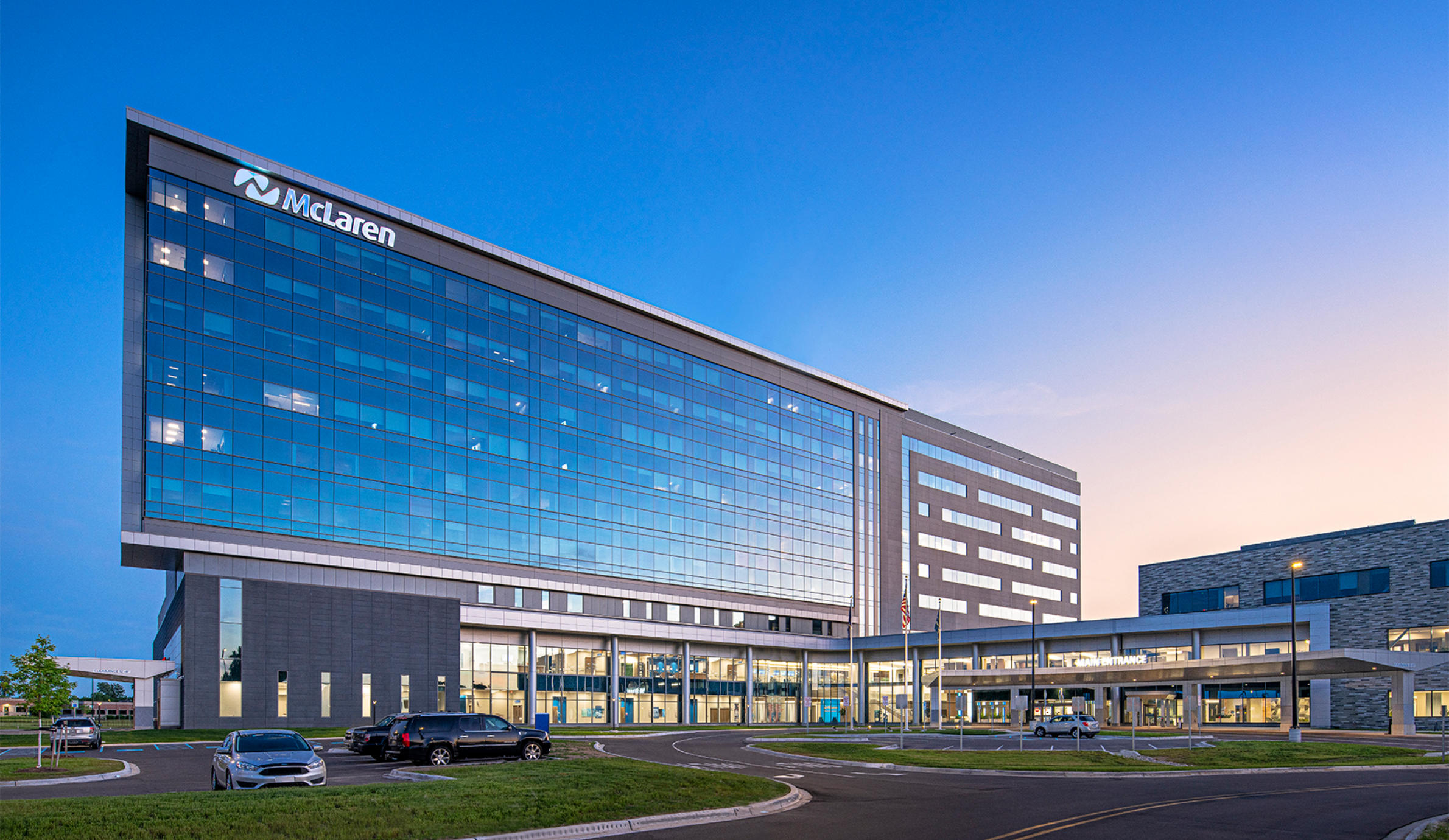 McLaren Greater Lansing hospital tower at dusk, a 3,840-ton Casadei Steel project